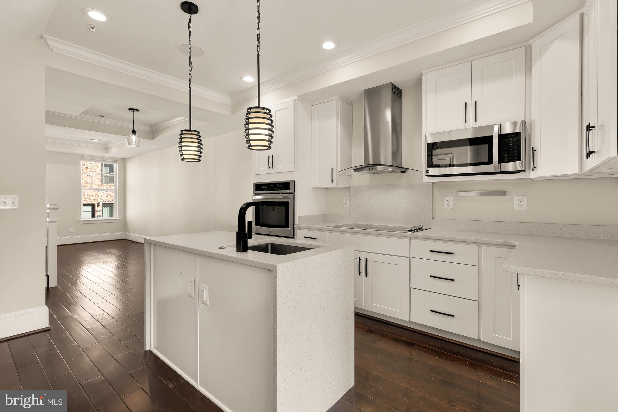 1609 Levis Street Northeast Washington, DC 20002 - Photo 9 of 35 a kitchen with stainless steel appliances granite countertop a sink a stove and a wooden floors