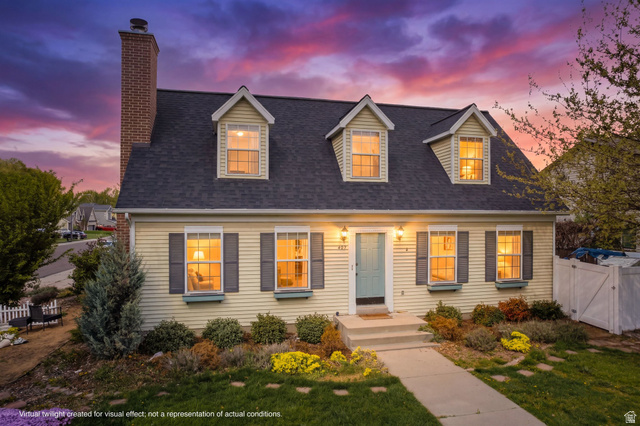 Cape cod-style house featuring a gate, a shingled roof, and a chimney