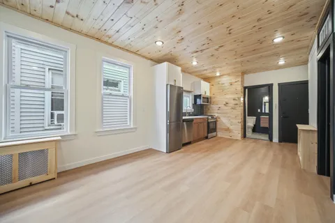 a view of kitchen with refrigerator and window