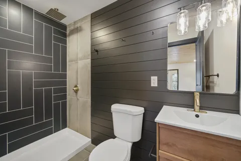 a bathroom with a toilet a sink and mirror