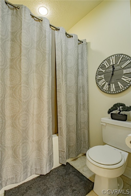 6809 West Quaker Road Disputanta, VA 23842 - Photo 20 of 49 a bathroom with a toilet and a shower curtain