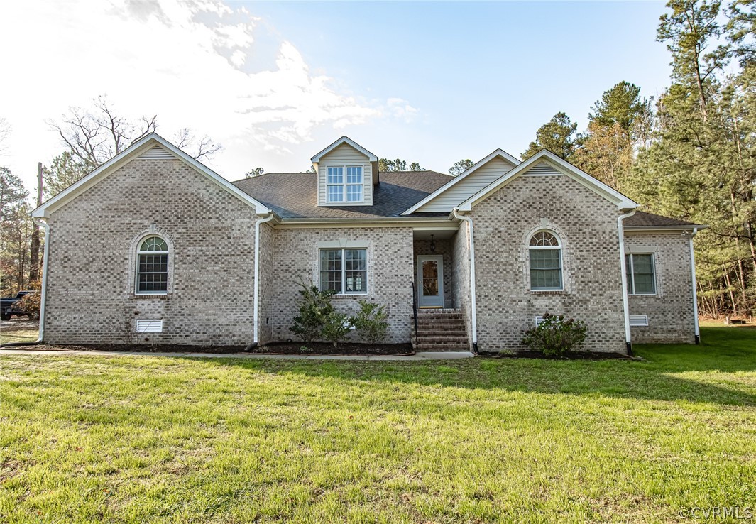 6809 West Quaker Road Disputanta, VA 23842 - Photo 2 of 49 a front view of a house with a yard