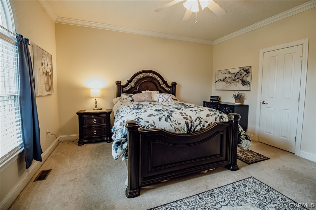 6809 West Quaker Road Disputanta, VA 23842 - Photo 26 of 49 a bed sitting in a bedroom next to a window