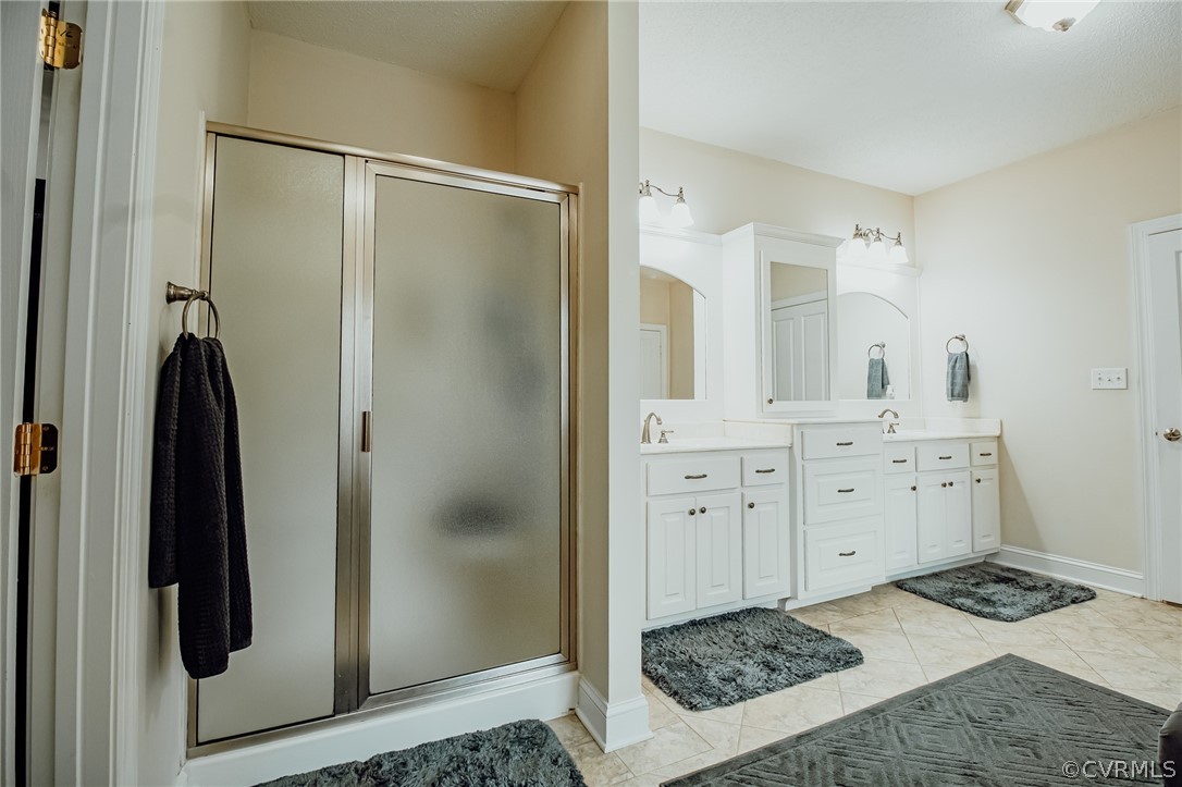 6809 West Quaker Road Disputanta, VA 23842 - Photo 34 of 49 a bathroom with a sink and a mirror a shower
