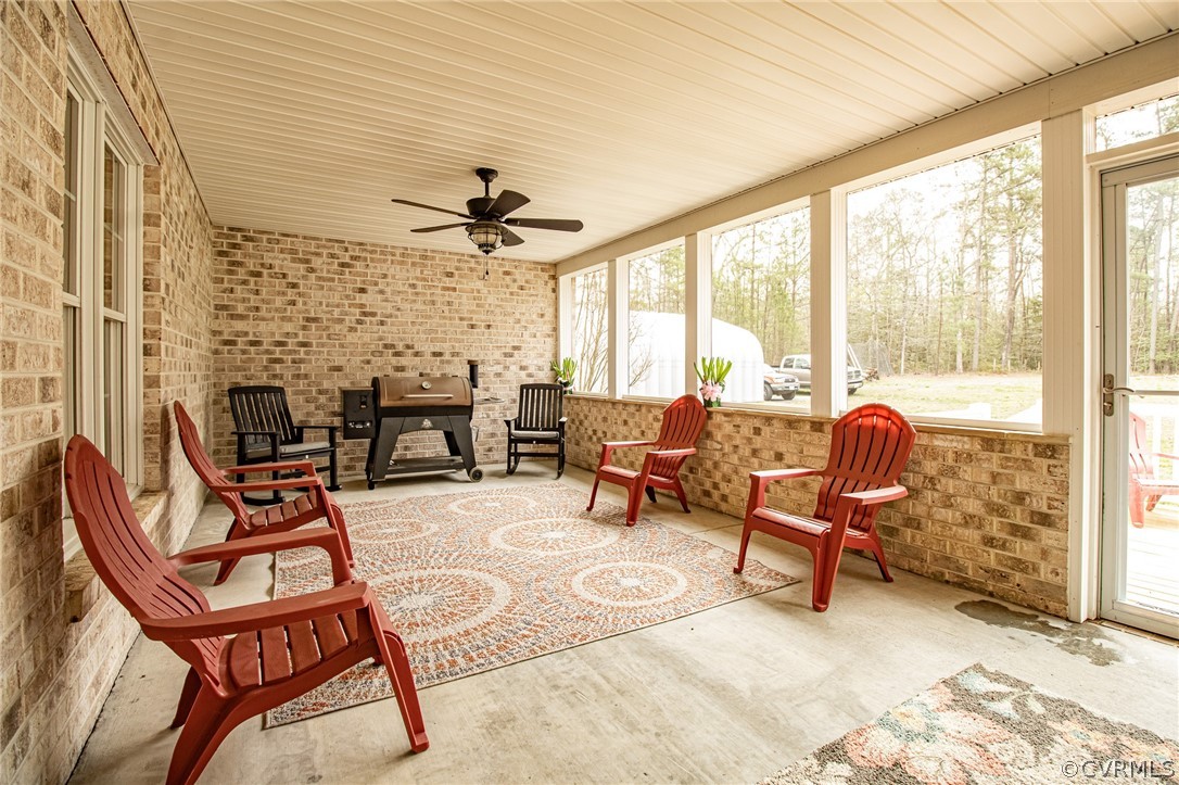 6809 West Quaker Road Disputanta, VA 23842 - Photo 38 of 49 a living room filled with furniture and a fireplace