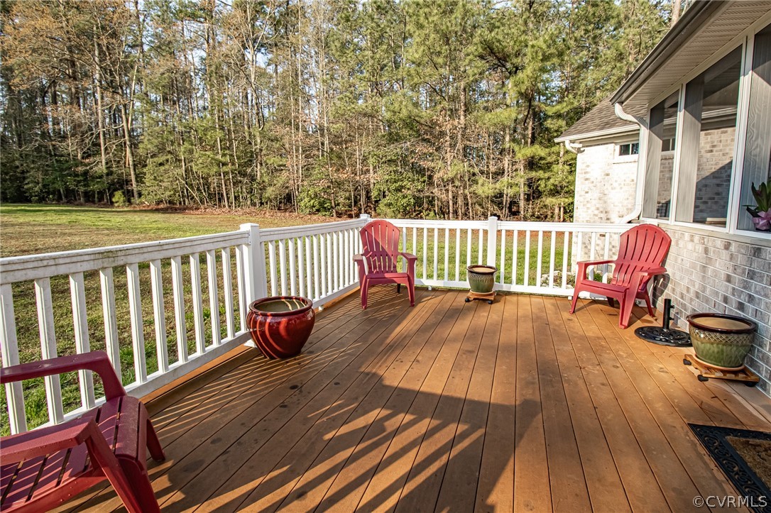 6809 West Quaker Road Disputanta, VA 23842 - Photo 44 of 49 a view of balcony with wooden floor and outdoor seating