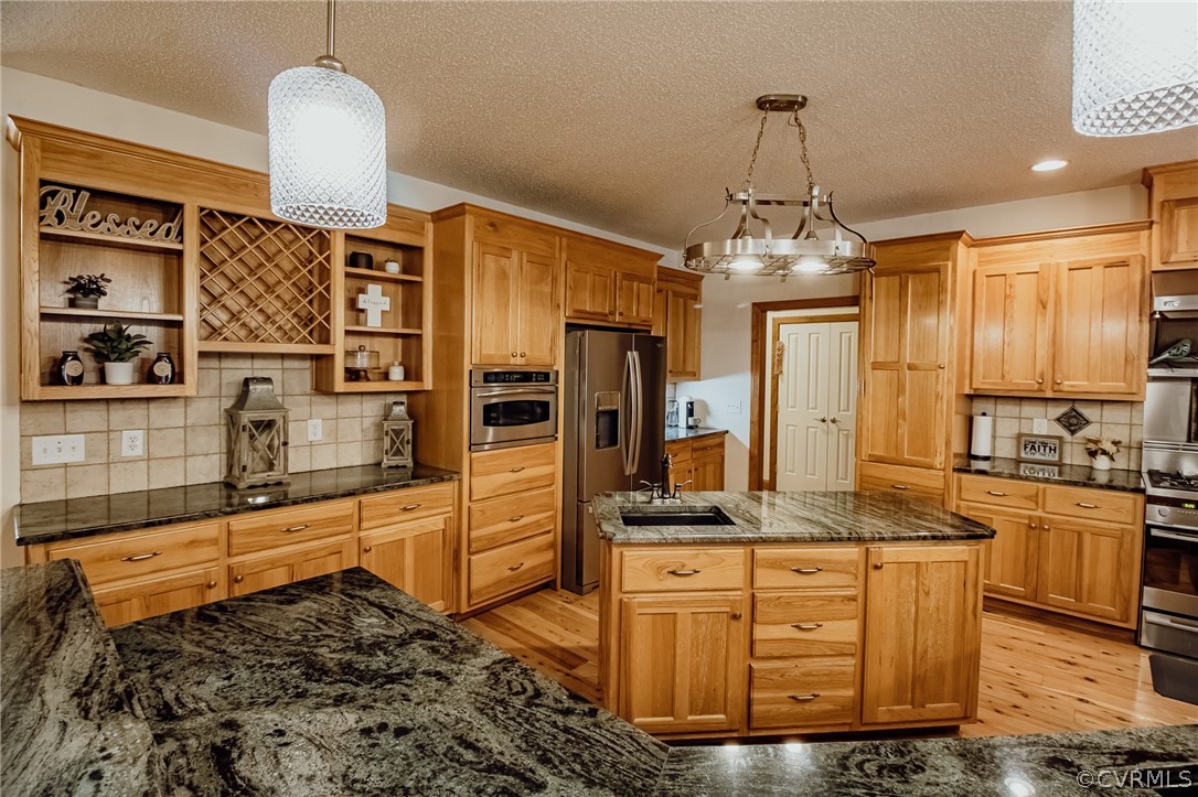 6809 West Quaker Road Disputanta, VA 23842 - Photo 5 of 49 a kitchen with stainless steel appliances kitchen island granite countertop a stove and cabinets