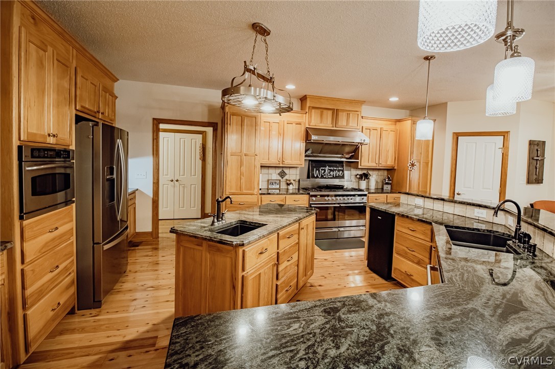 6809 West Quaker Road Disputanta, VA 23842 - Photo 7 of 49 a kitchen with stainless steel appliances granite countertop a sink stove and refrigerator