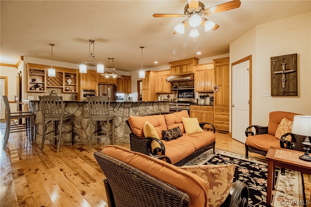 6809 West Quaker Road Disputanta, VA 23842 - Photo 10 of 49 a living room with furniture and a chandelier