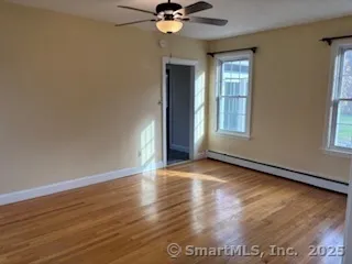 wooden floor in an empty room with a window