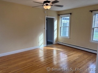 175 Pine Street Columbia, CT 06237 - Photo 12 of 29 wooden floor in an empty room with a window