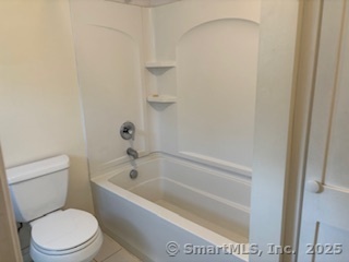 175 Pine Street Columbia, CT 06237 - Photo 15 of 29 a white toilet sitting next to a bath tub