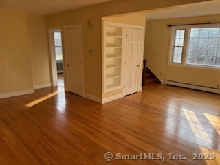 175 Pine Street Columbia, CT 06237 - Photo 19 of 29 an empty room with wooden floor and windows