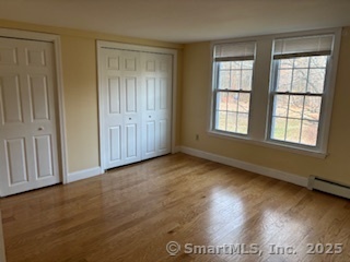 175 Pine Street Columbia, CT 06237 - Photo 26 of 29 an empty room with wooden floor and windows