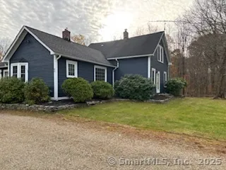 a front view of house with yard and trees around