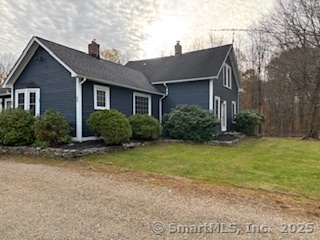 175 Pine Street Columbia, CT 06237 - Photo 4 of 29 a front view of house with yard and trees around