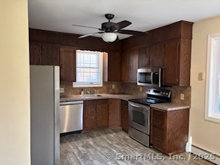175 Pine Street Columbia, CT 06237 - Photo 10 of 29 a kitchen with stainless steel appliances granite countertop a sink a stove a refrigerator cabinets and a window