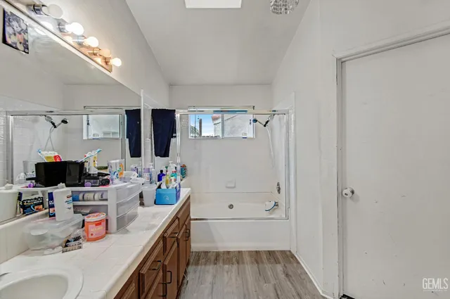 a kitchen that has a lot of cabinets a washer and dryer