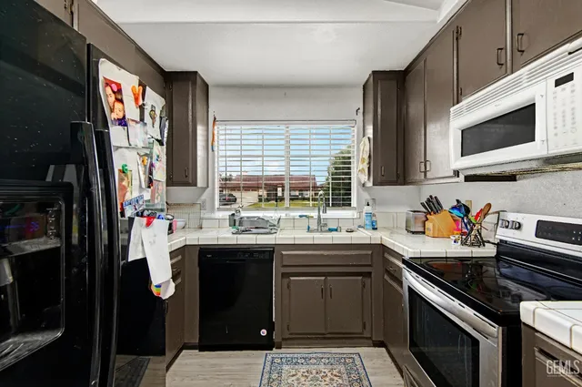a kitchen with lots of counter top space appliances and a sink