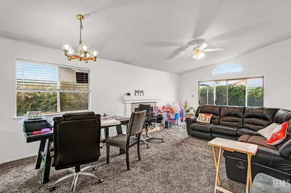 a living room with furniture a window and a chandelier