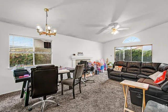 a living room with furniture a window and a chandelier