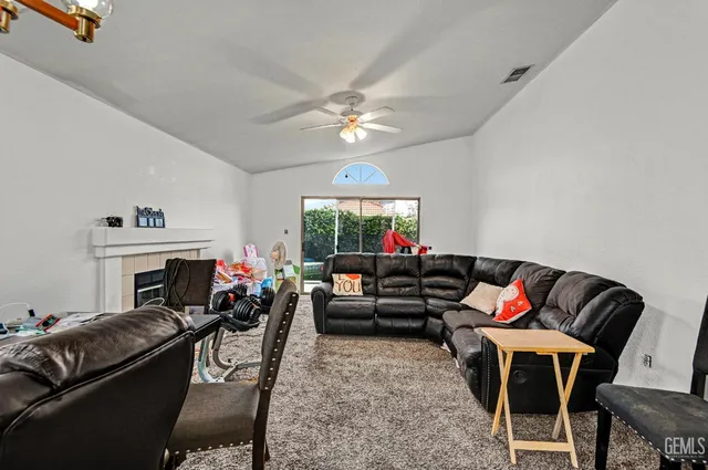 a living room with furniture a fireplace and a chandelier