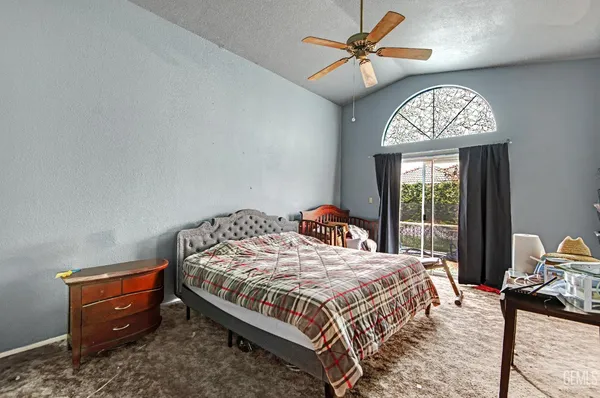 a bedroom with a bed and a chandelier