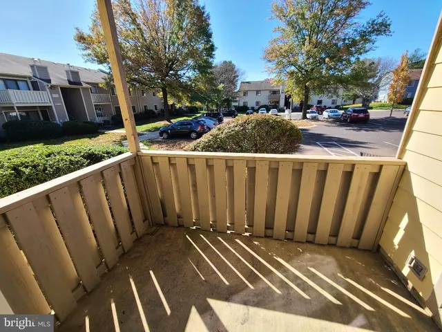 a view of a street with wooden fence