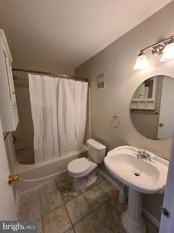 a bathroom with a sink toilet and mirror
