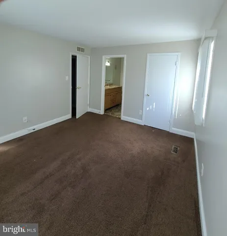 a view of an empty room with closet area