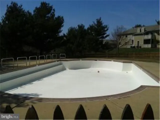a view of swimming pool with outdoor seating and seating in kitchen