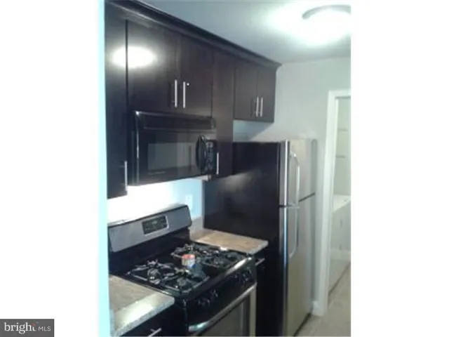 a kitchen with a sink and refrigerator