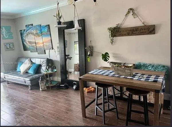a view of a dining room with furniture and wooden floor