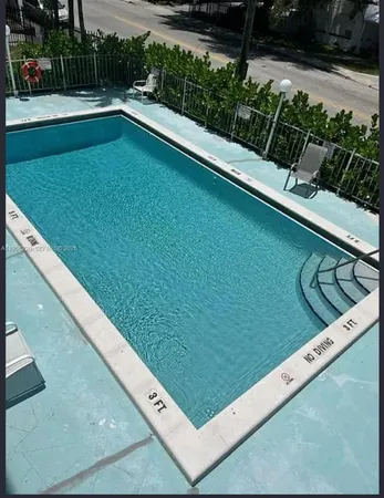 a view of swimming pool from a balcony
