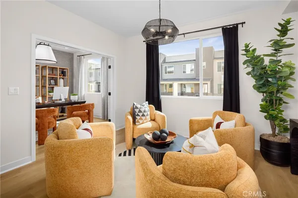 a living room with furniture and a chandelier