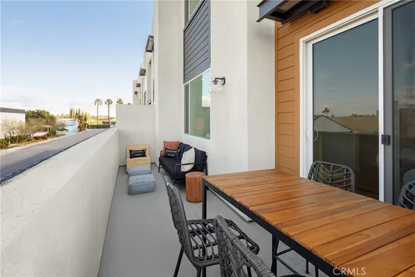 a balcony with table and chairs