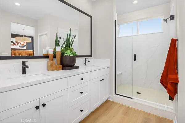 a bathroom with a shower sink and mirror