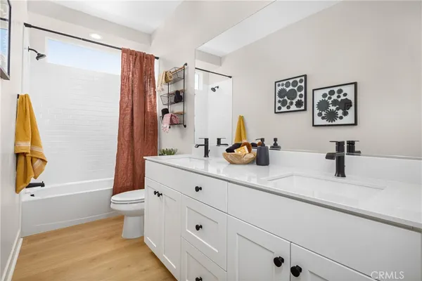 a bathroom with a granite countertop sink mirror vanity and toilet