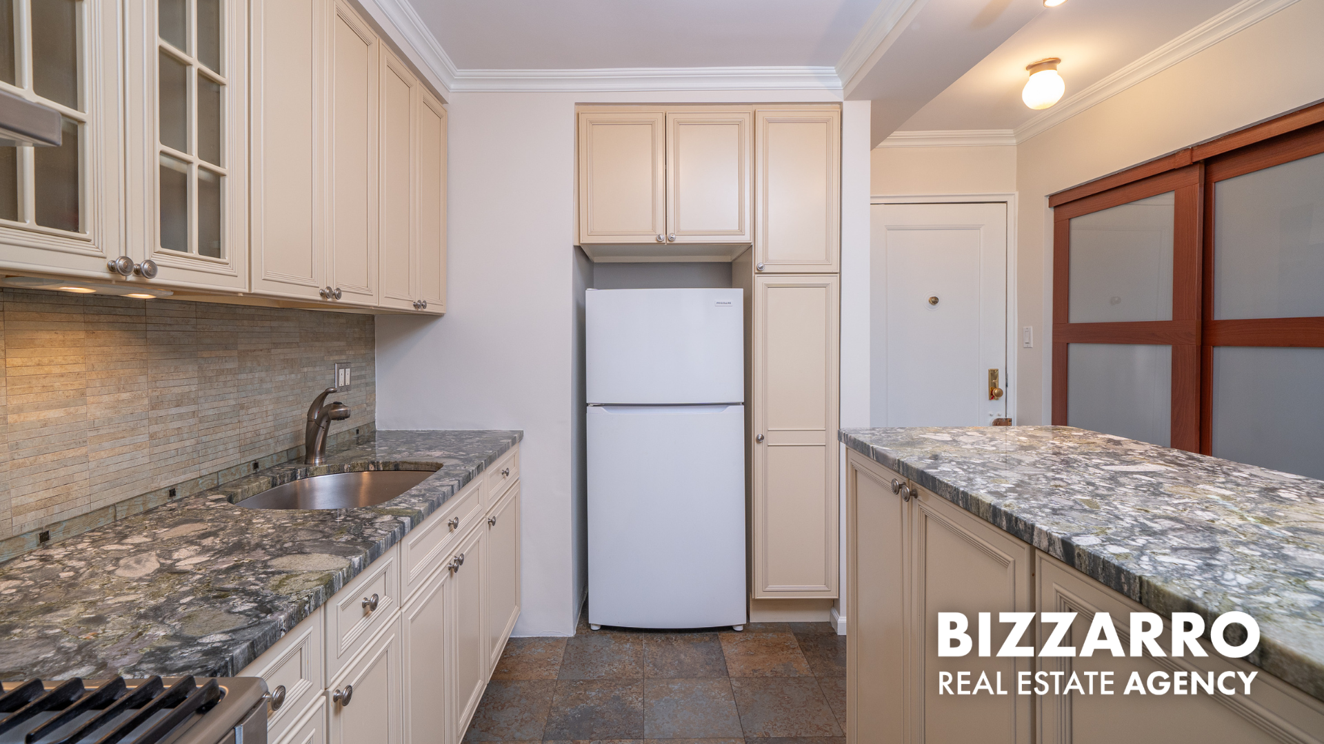 a kitchen with granite countertop kitchen island stainless steel appliances granite countertop a refrigerator and a sink