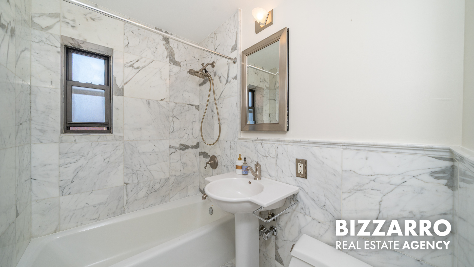 25-10 31st Avenue, Unit 5G Queens, NY 11106 - Photo 12 of 14 a bathroom with a shower and a sink