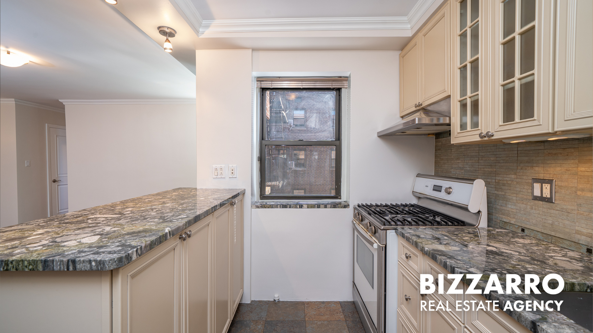 25-10 31st Avenue, Unit 5G Queens, NY 11106 - Photo 2 of 14 a kitchen with granite countertop a stove and cabinets