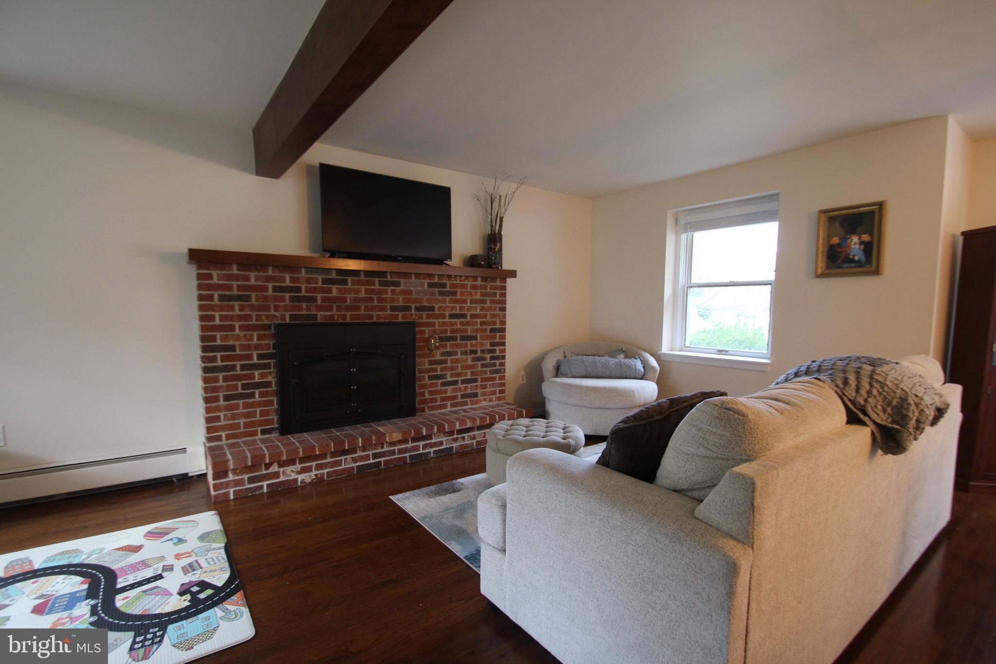 201 Spruce Road Flourtown, PA 19031 - Photo 8 of 39 a living room with furniture and a fireplace