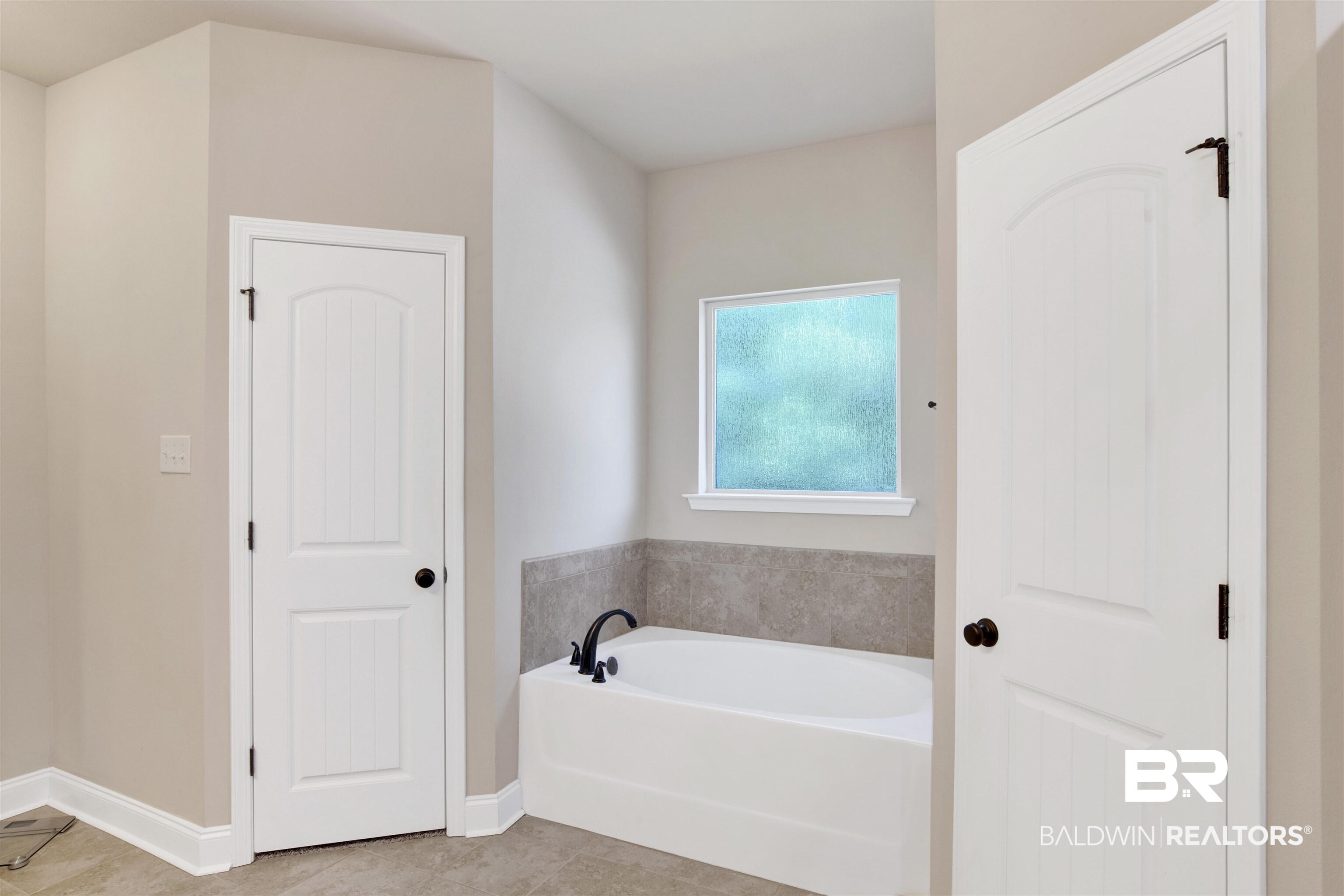 21282 Merlot Loop Silverhill, AL 36576 - Photo 19 of 27 Bathroom with tile patterned flooring and a tub to relax in