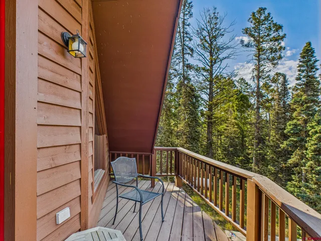 a living room with furniture a window and a flat screen tv
