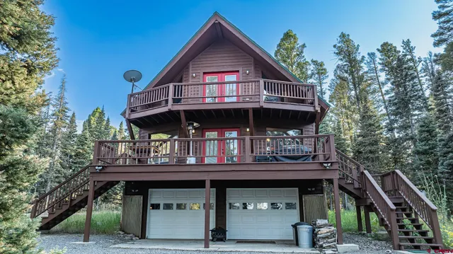 a view of house with outdoor space and deck