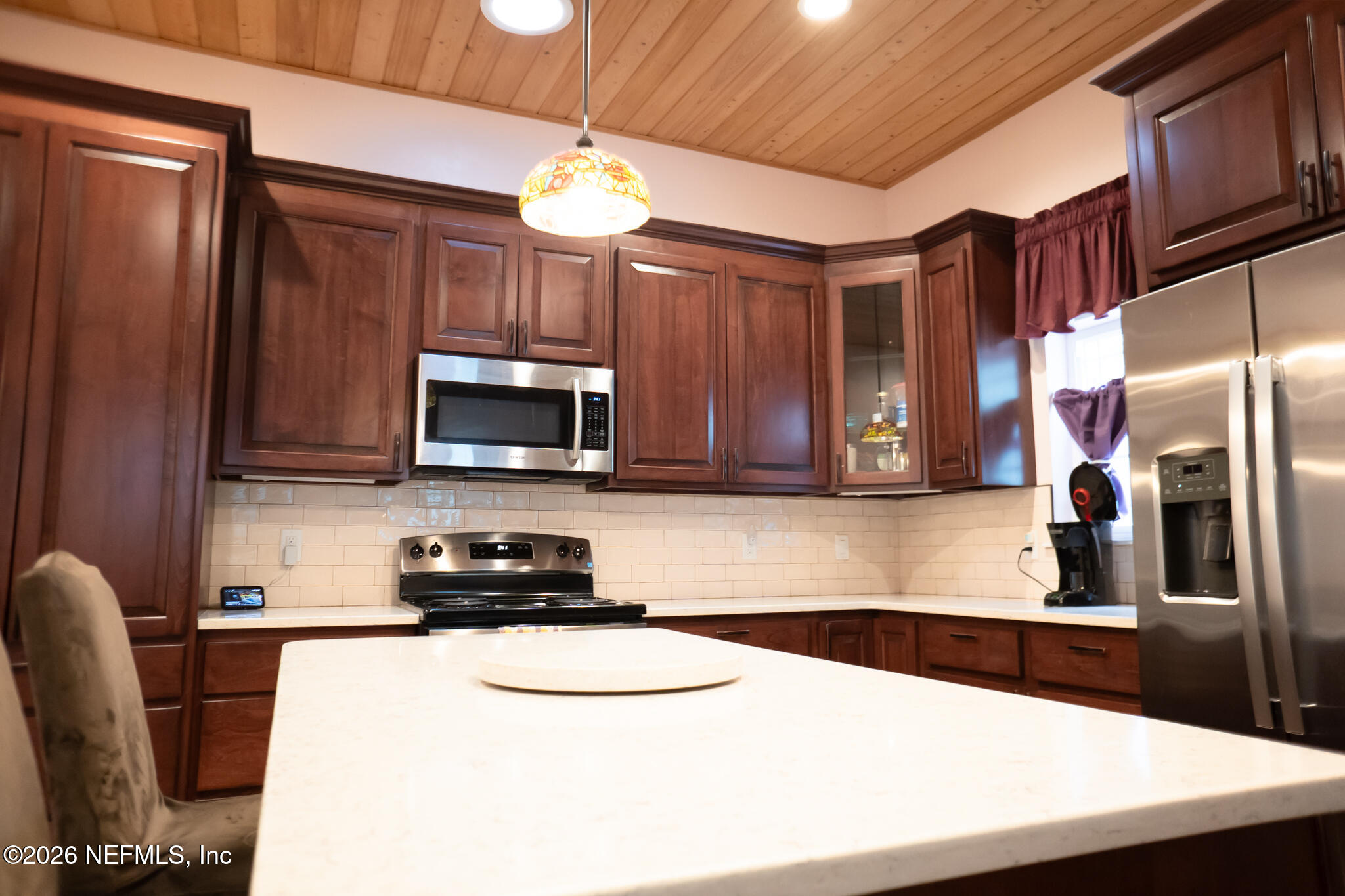 161 Southwest Jasmine Avenue Keystone Heights, FL 32656 - Photo 12 of 47 a kitchen with stainless steel appliances a sink a stove a microwave a refrigerator a stove and cabinets