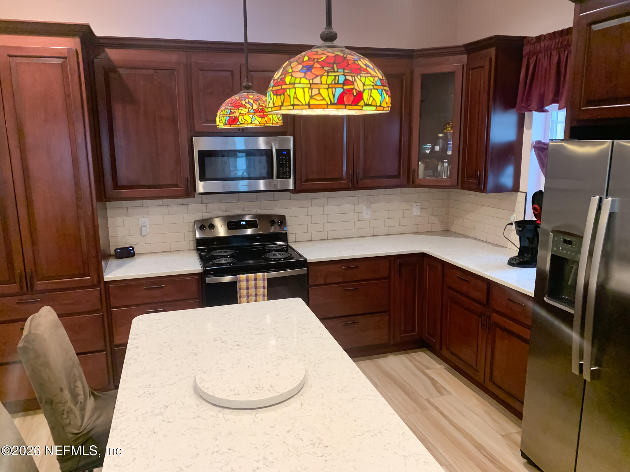 161 Southwest Jasmine Avenue Keystone Heights, FL 32656 - Photo 13 of 47 a kitchen with stainless steel appliances a stove a microwave and a refrigerator