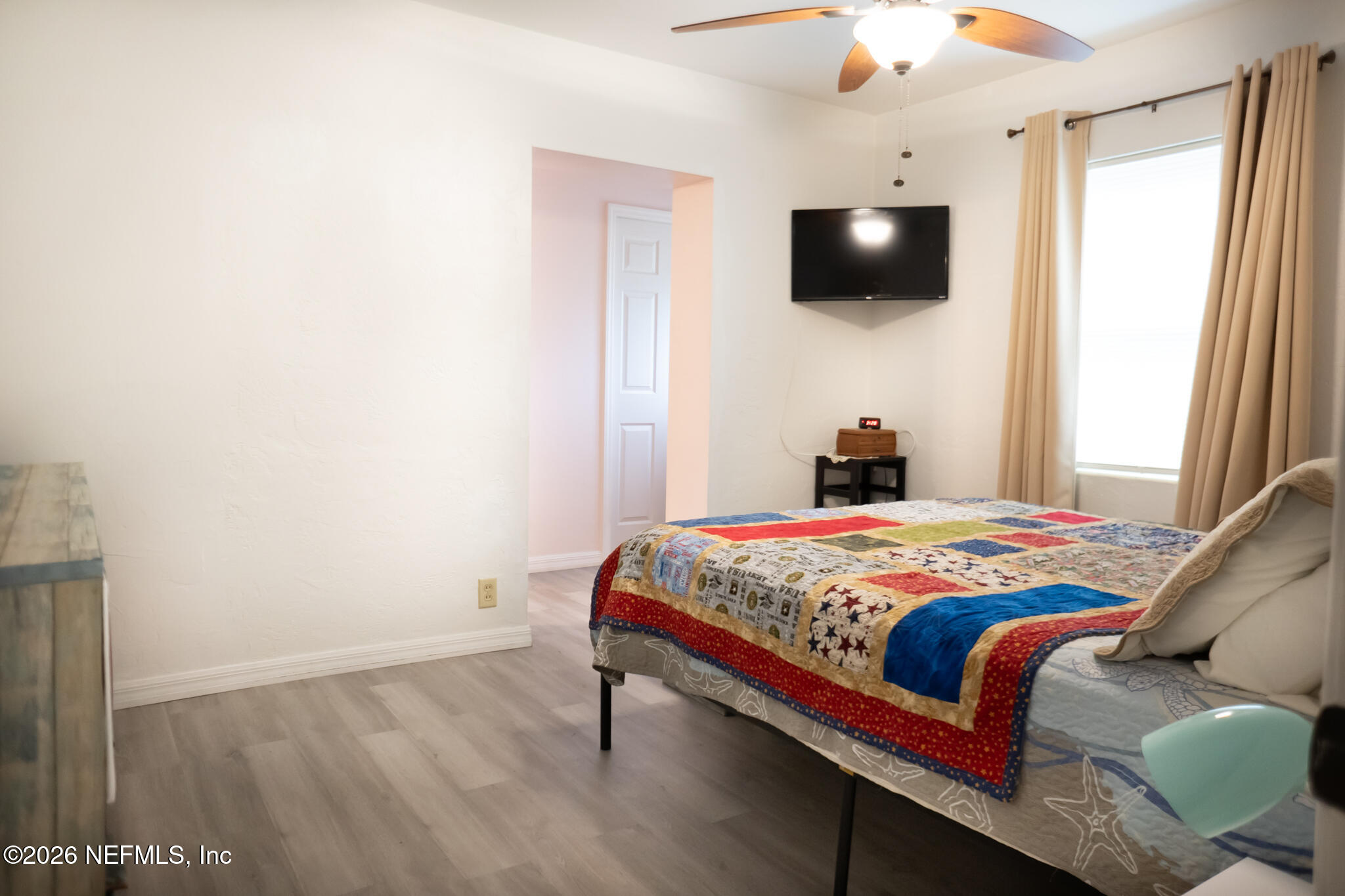 161 Southwest Jasmine Avenue Keystone Heights, FL 32656 - Photo 16 of 47 a bedroom with a bed and a flat tv screen on dresser