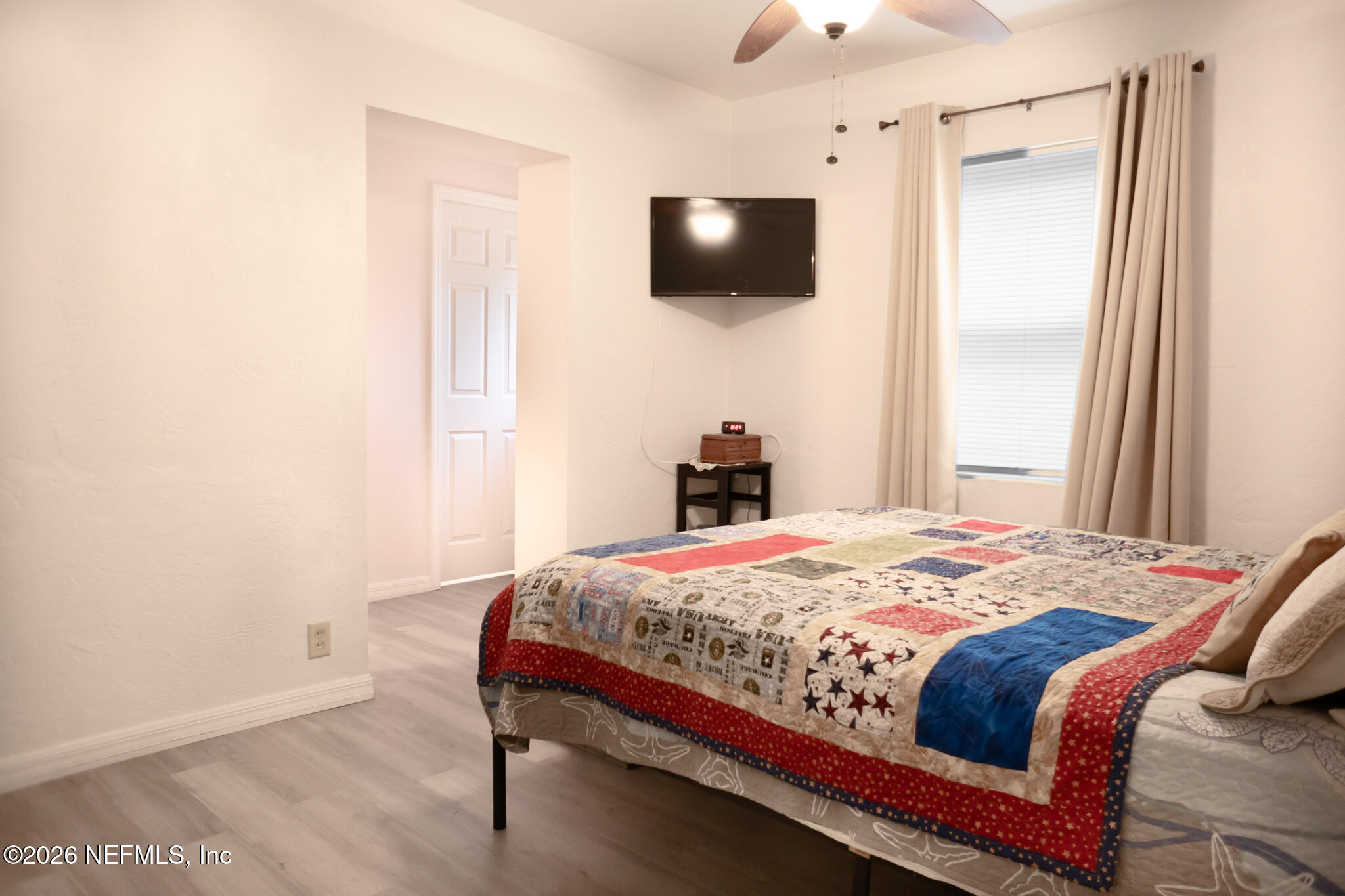 161 Southwest Jasmine Avenue Keystone Heights, FL 32656 - Photo 17 of 47 a bedroom with a bed a flat screen tv and guitar