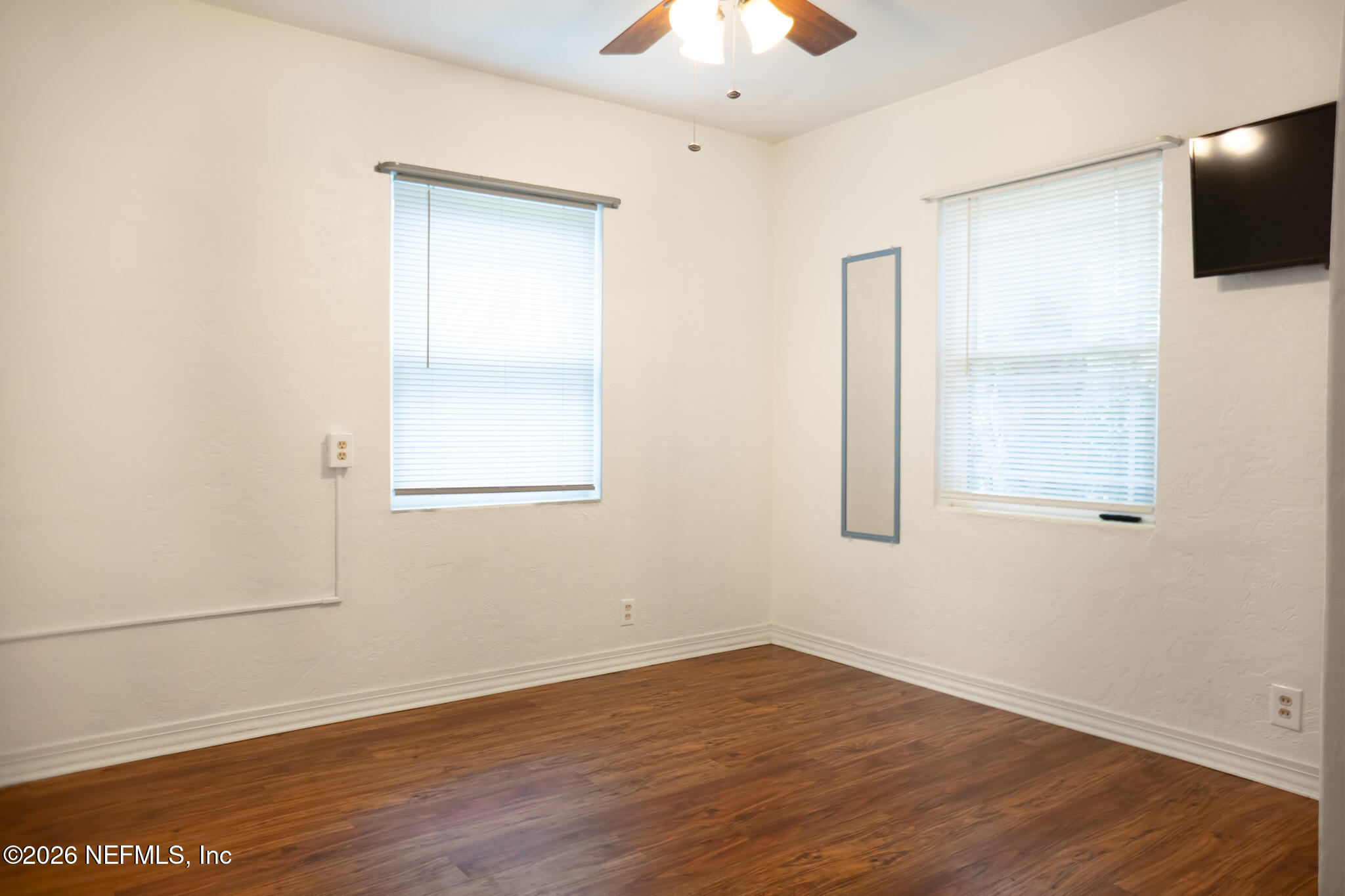 161 Southwest Jasmine Avenue Keystone Heights, FL 32656 - Photo 24 of 47 an empty room with wooden floor and windows